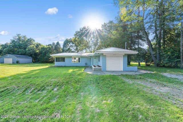 single story home featuring a garage and a front lawn