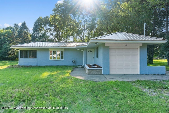 single story home with a front lawn and a garage