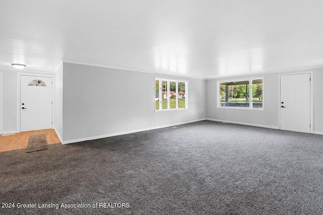 unfurnished living room featuring carpet flooring