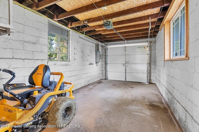 garage featuring electric panel and a garage door opener