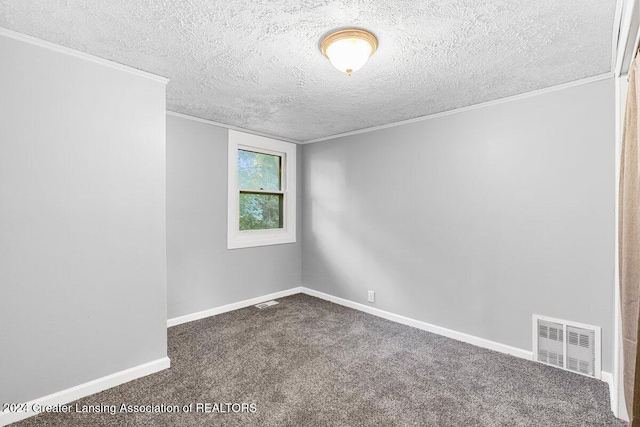 carpeted spare room featuring a textured ceiling