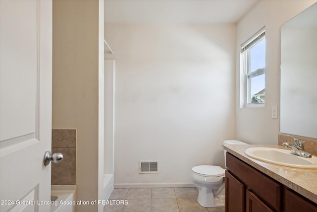 bathroom with toilet, vanity, and tile patterned floors