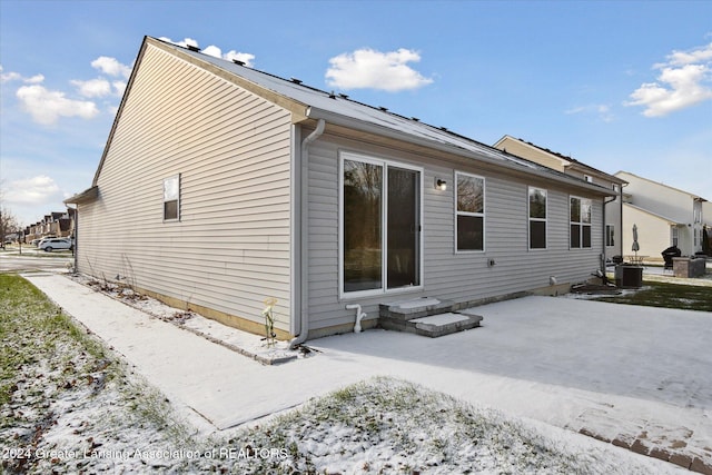 view of snowy exterior with central AC