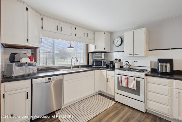 kitchen with backsplash, stainless steel appliances, white cabinetry, and sink