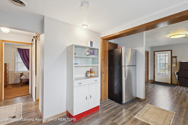 kitchen featuring stainless steel fridge and dark wood-type flooring