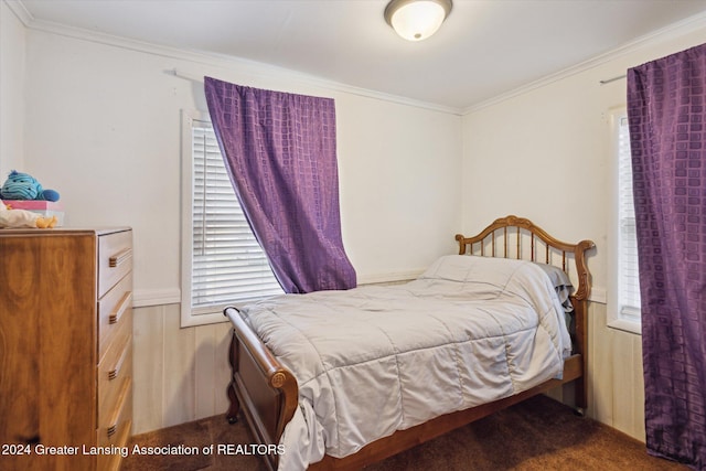 bedroom featuring dark carpet and crown molding