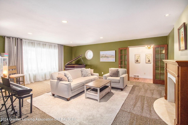 carpeted living room featuring an inviting chandelier