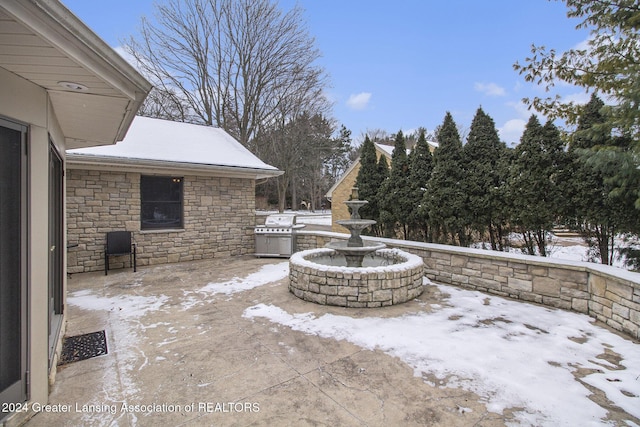 snow covered patio with grilling area