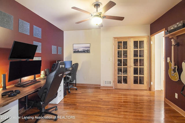 office space with ceiling fan and light hardwood / wood-style floors