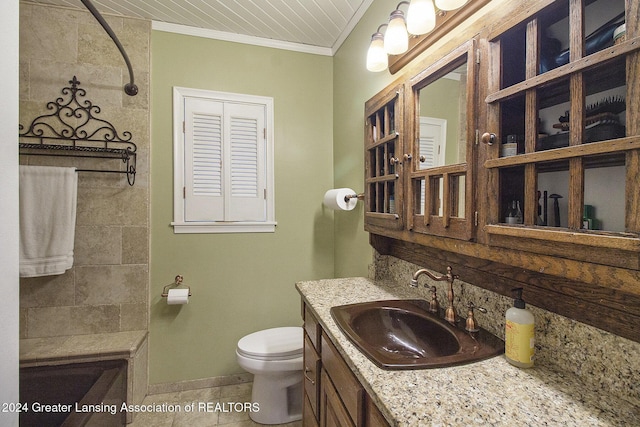 bathroom featuring vanity, a shower, crown molding, tile patterned flooring, and toilet