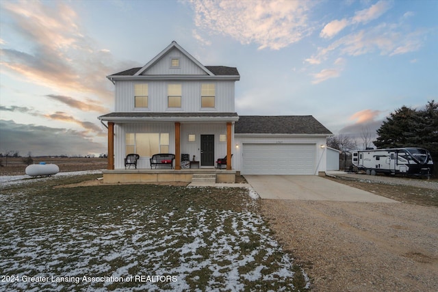 view of front of home featuring a porch and a garage