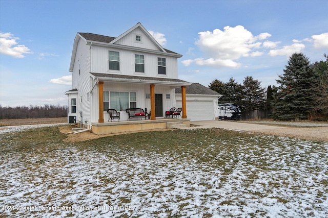 view of front of house featuring cooling unit, a porch, and a garage