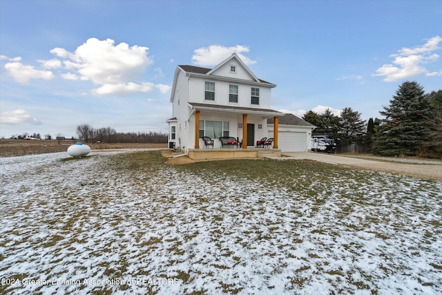 view of front of house with a porch and a garage