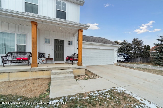 doorway to property featuring a porch and a garage