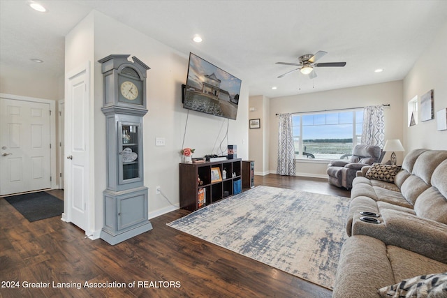 living room with dark hardwood / wood-style floors and ceiling fan