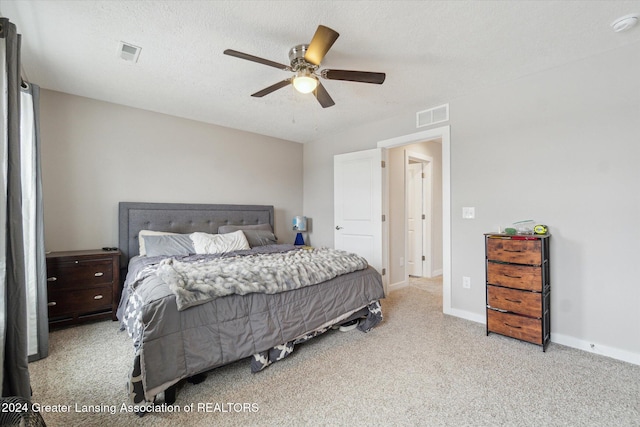 bedroom featuring ceiling fan and a textured ceiling