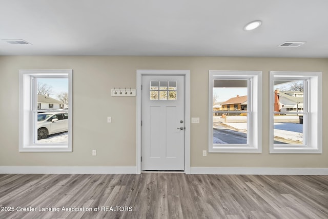 foyer with a wealth of natural light, visible vents, and baseboards