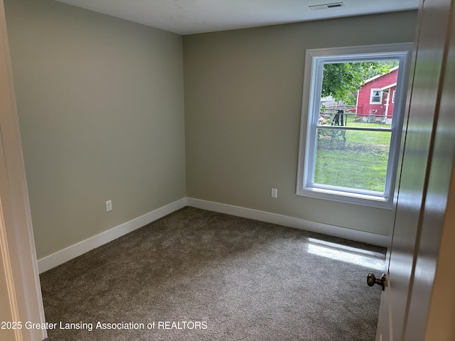 301 Meyers Ave, Jackson, MI 49203 - spare room featuring dark carpet and baseboards