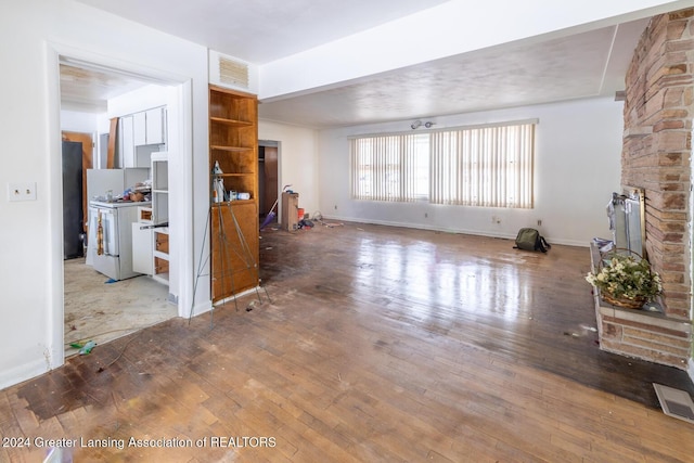 unfurnished living room featuring hardwood / wood-style flooring and a fireplace