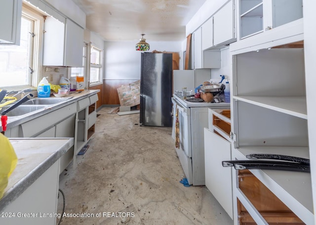 kitchen with white cabinets, white electric range, black fridge, and sink