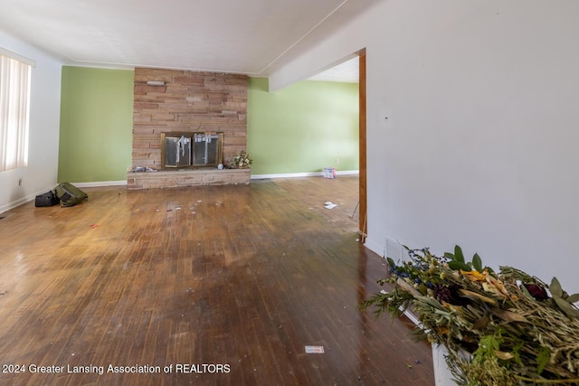 unfurnished living room with a fireplace and hardwood / wood-style floors