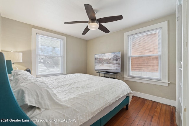 bedroom with ceiling fan and dark hardwood / wood-style flooring