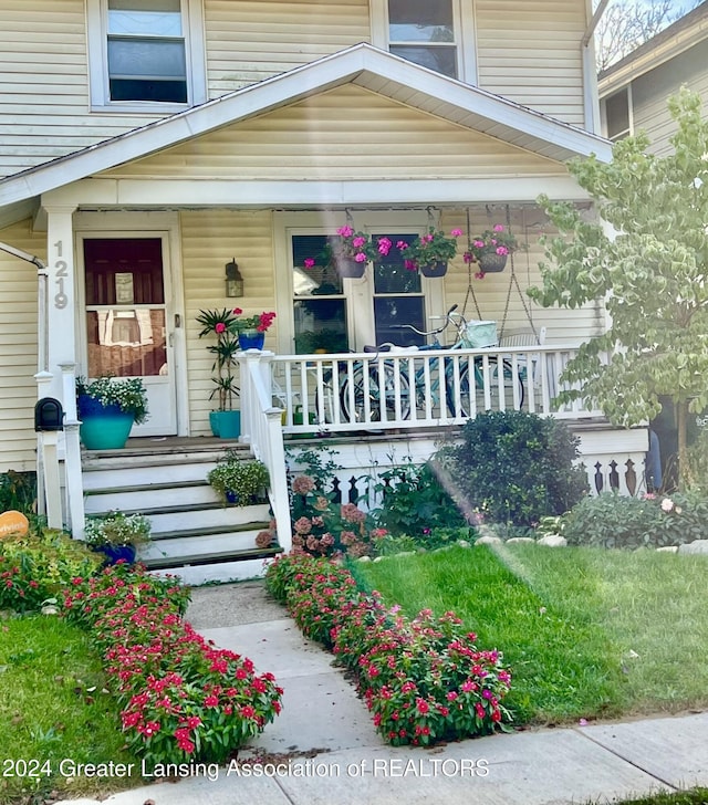 doorway to property featuring covered porch