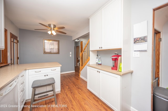 kitchen with kitchen peninsula, white dishwasher, ceiling fan, light hardwood / wood-style flooring, and white cabinetry