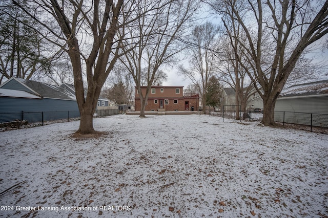 view of yard layered in snow