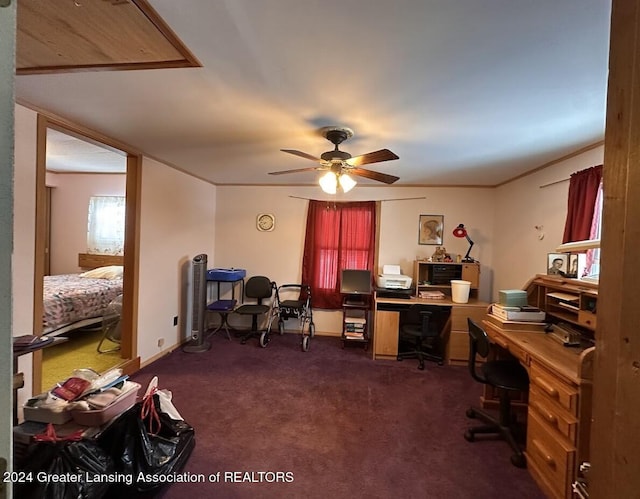 office space featuring dark carpet and ceiling fan