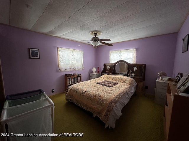 carpeted bedroom featuring a textured ceiling and ceiling fan