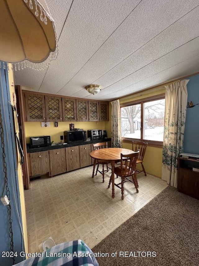 dining area featuring a textured ceiling