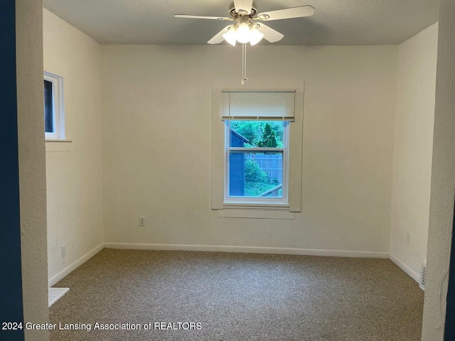 spare room with ceiling fan and carpet floors