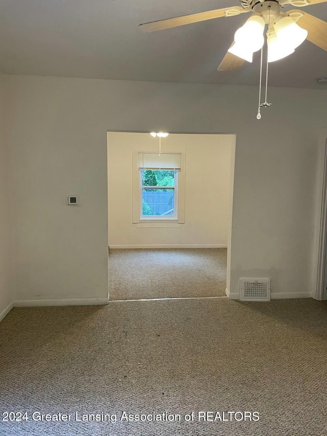 spare room featuring carpet flooring and ceiling fan