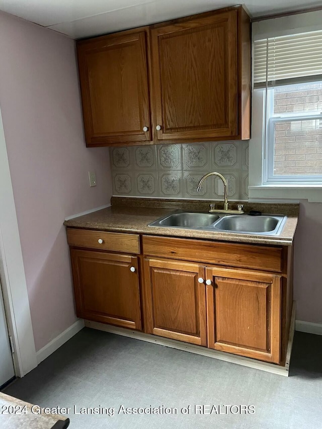 kitchen featuring backsplash and sink