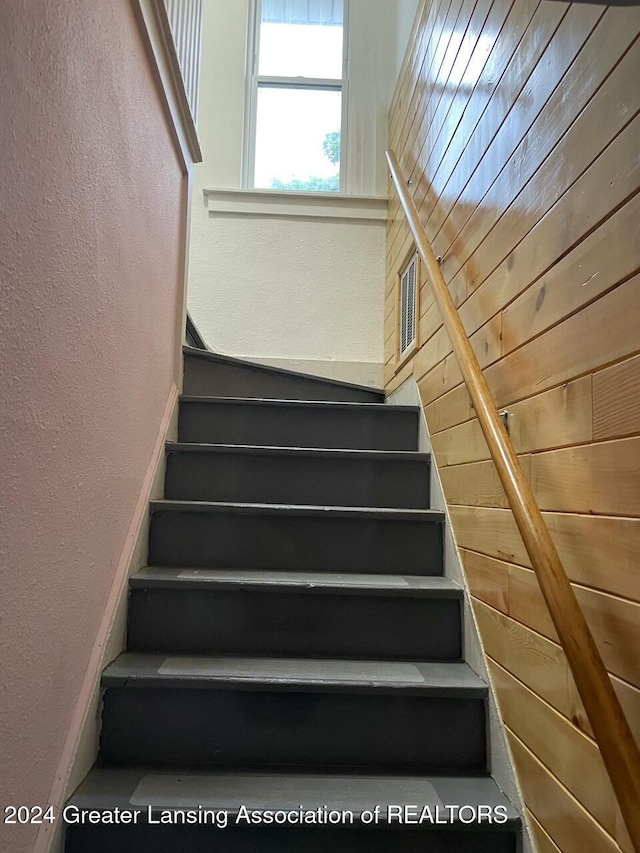 staircase with wooden walls