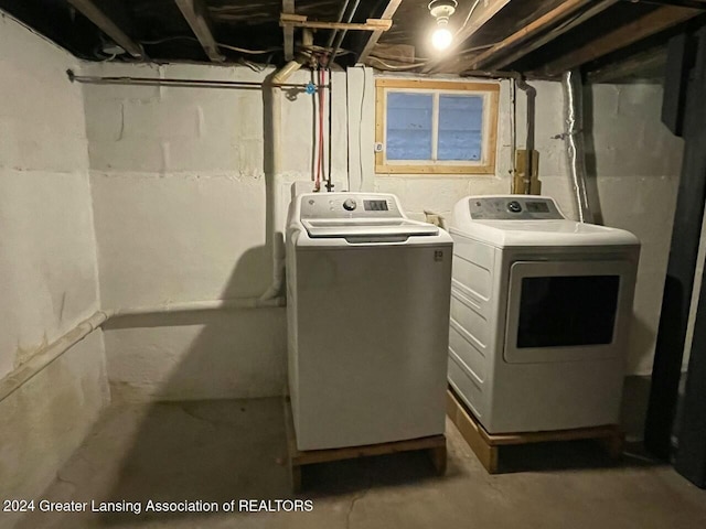 clothes washing area featuring washer and clothes dryer