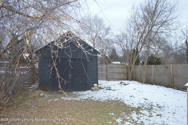 yard covered in snow featuring an outbuilding