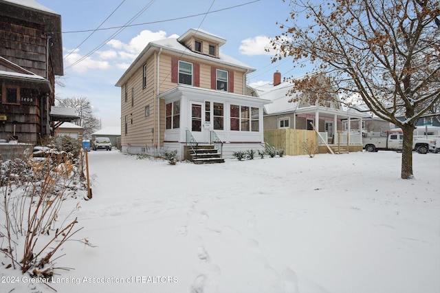 view of snow covered rear of property