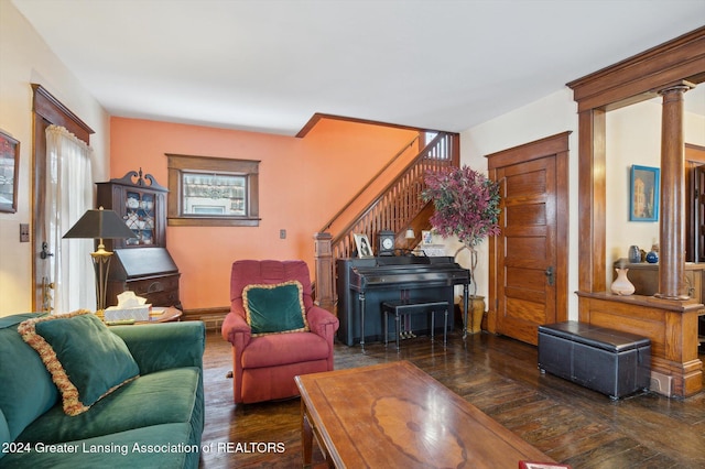 living room with dark hardwood / wood-style floors and decorative columns