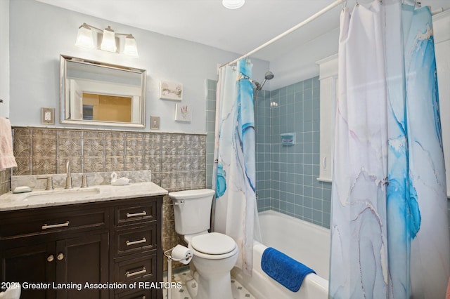 full bathroom with backsplash, toilet, shower / bath combo with shower curtain, vanity, and tile walls