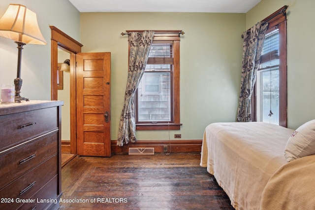 bedroom with dark wood-type flooring