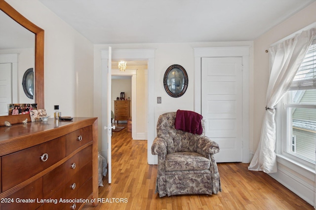 living area with a wealth of natural light and light hardwood / wood-style floors