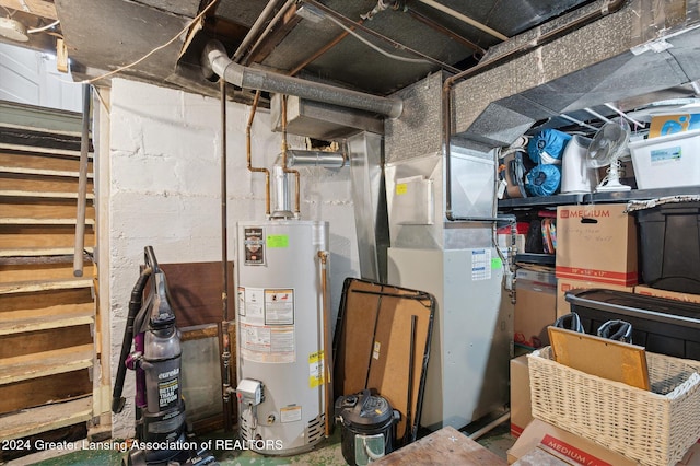 utility room with heating unit and gas water heater