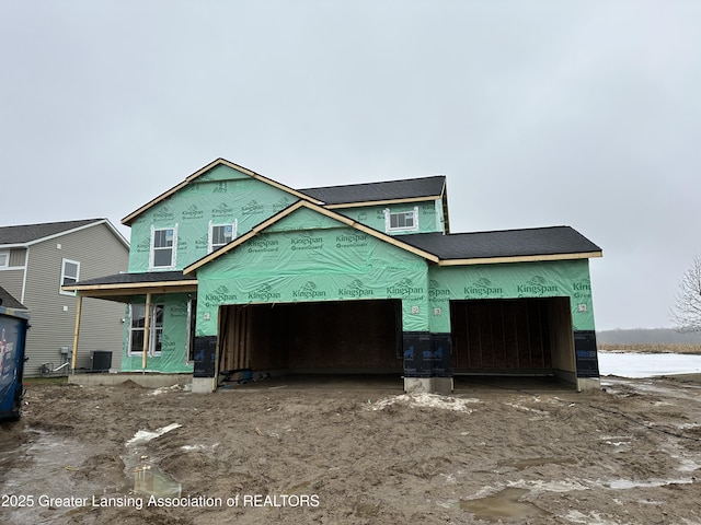 unfinished property with a garage, central AC, and covered porch