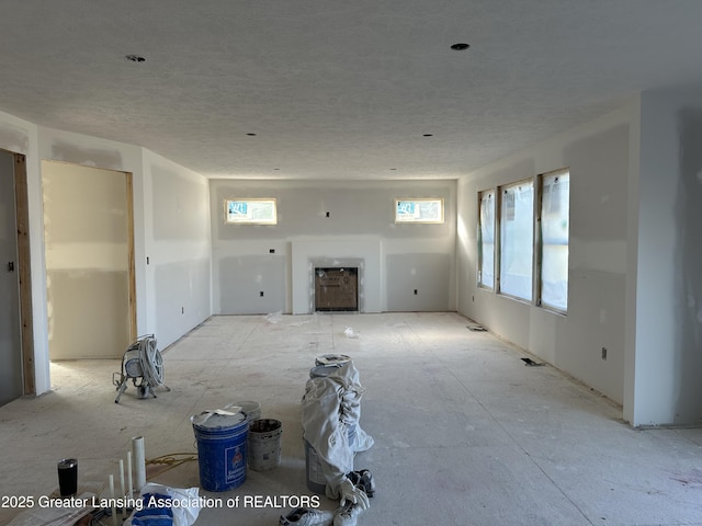 unfurnished living room featuring a textured ceiling