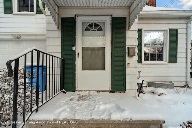 view of snow covered property entrance