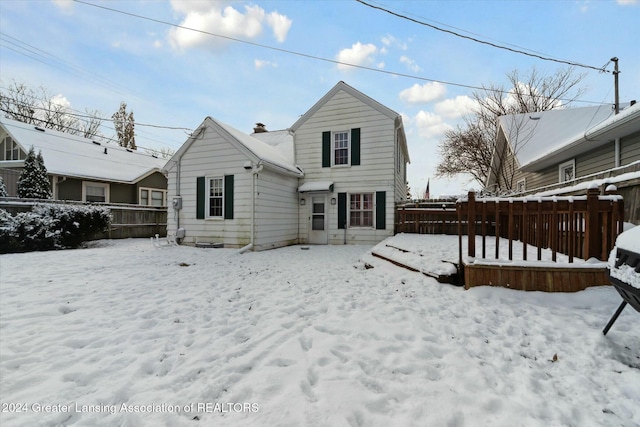 view of snow covered rear of property