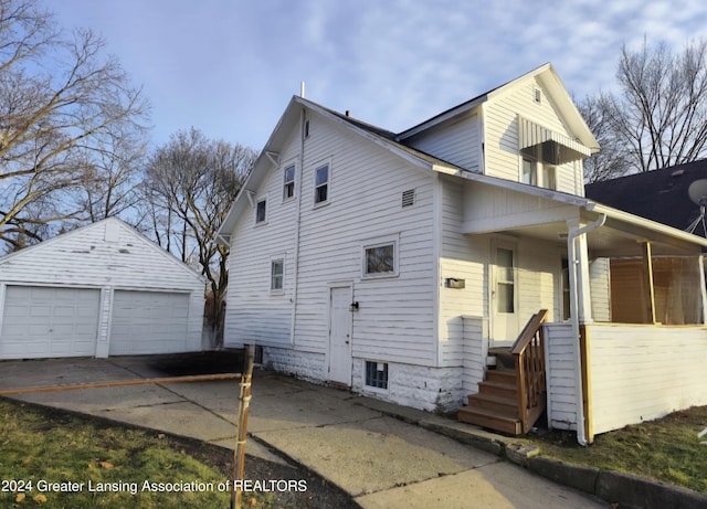 view of home's exterior with an outbuilding, covered porch, and a garage