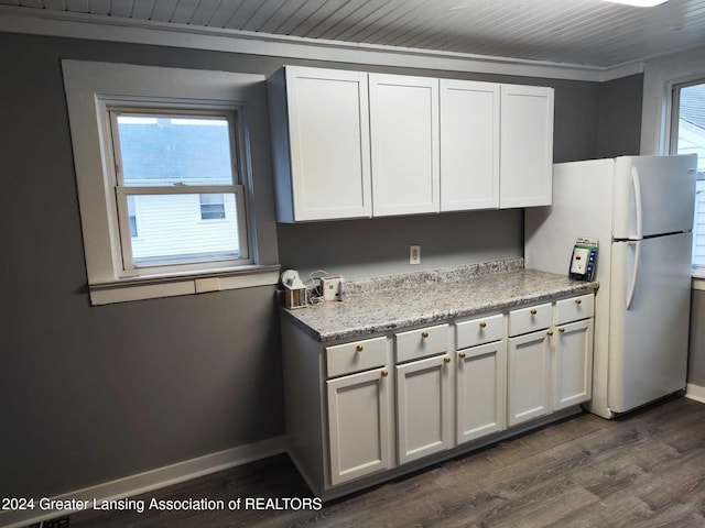 kitchen with white cabinetry, dark hardwood / wood-style flooring, refrigerator, and crown molding